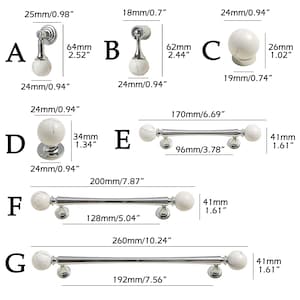 May include: A range of cabinet hardware featuring white marble-effect spheres and silver-coloured metal bases. Includes knobs and pulls of various sizes, with measurements in millimetres.