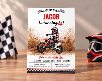 May include: A rectangular birthday invitation card featuring a cartoon motocross rider on a red motorcycle kicking up mud. The text reads: RACE ON OVER JACOB is turning 4! Join us to celebrate! SATURDAY OCTOBER 14TH 4:00-6:00 PM, with address and RSVP details.