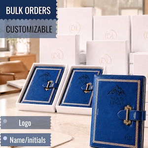 Può includere: Diari blu in similpelle con chiusura a scatto in metallo, caratterizzati da un grafico di montagna, il testo "YOUR LOGO" e le iniziali "HR" impresse sulla copertina. I diari sono presentati in scatole regalo bianche con scatole abbinate sullo sfondo.
