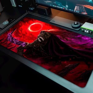 May include: A rectangular gaming mousepad featuring a fantasy warrior design. The artwork depicts a figure with long hair and a cape, holding a glowing purple sword against a red and purple background with a circular element.
