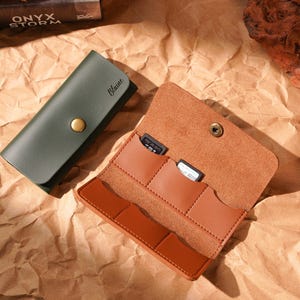 Puede incluir: Un juego de tres tazas de cerámica con un esmalte moteado de color crema. Cada taza presenta un diseño floral pintado a mano en tonos azules, verdes y amarillos. Las tazas tienen una forma simple y redondeada y un asa cómoda.