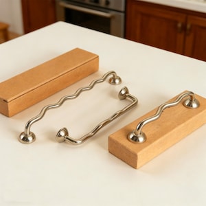 May include: A set of three ceramic mugs with a speckled, matte finish. Each mug is a different colour: light blue, cream, and grey. The mugs have a simple, modern design, suitable for coffee or tea.