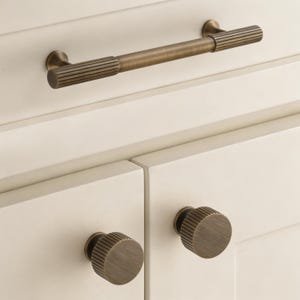 May include: A weathered wooden sign, inscribed with "Welcome to our home" in white. The sign has a distressed appearance, suggesting a vintage aesthetic, and is suitable for a porch or hallway.