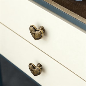 May include: A set of three ceramic mugs with a speckled, matte finish. The mugs are in shades of cream, light gray, and dark gray. Each mug has a simple, minimalist design, perfect for coffee or tea.