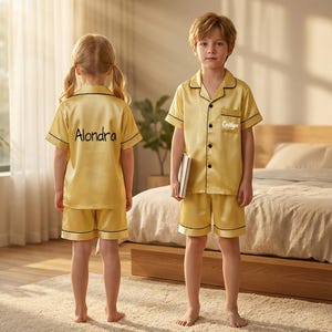 May include: A set of three ceramic mugs with a speckled, matte finish. The mugs are in shades of cream, light gray, and dark gray. Each mug has a simple, minimalist design and a rounded handle.