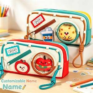 May include: Two rectangular pencil cases with cream-colored fronts and colorful accents. The top case is teal and yellow with a red patch reading NICE DAY and a circular window. The bottom case is red and teal with a blue patch reading NICE DAY.