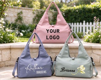 May include: Three tote bags with shoulder straps in pink, light blue, and sage green. The pink bag features the text YOUR LOGO. The blue bag displays the text Arthur BRIDE. The green bag shows the name Brianna with a floral graphic.