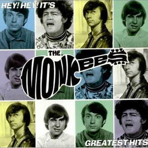 May include: A vintage album cover featuring a band called "The Monkees" with a guitar graphic and the text "Hey! Hey! It's The Monkees" and "Greatest Hits". The cover features six black and white photos of the band members.