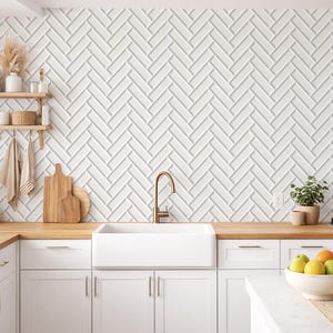 May include: A contemporary kitchen featuring white cabinetry, a farmhouse sink, and a gold tap. The backsplash showcases a white herringbone design. Wooden worktops and shelves provide warmth. Woven pendant lights and a gas hob complete the space.