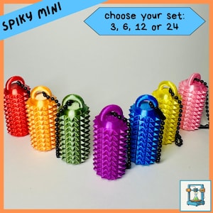May include: A selection of brightly coloured, spiky mini objects in red, orange, green, purple, blue, yellow, and pink. Each has a loop and a black beaded chain. Text reads "Spiky Mini" and "choose your set: 3, 6, 12 or 24."