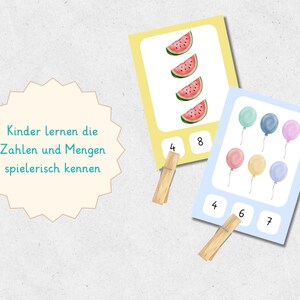 May include: Educational cards for children featuring watercolor illustrations of watermelon slices and balloons. The cards have numbers and wooden clothespins. The text on the image says "Kinder lernen die Zahlen und Mengen spielerisch kennen."
