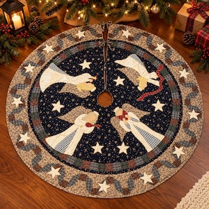 May include: A circular quilted Christmas tree skirt featuring a dark navy blue center with gold star patterns and four appliqued angels in white robes. The border consists of a tan floral print with a plaid ribbon design and white stars.