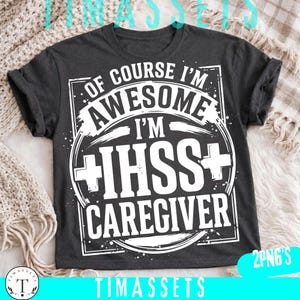 May include: A dark gray short-sleeved t-shirt featuring white graphic text that reads: OF COURSE I'M AWESOME I'M IHSS CAREGIVER. The design includes a circular frame with cross symbols on the left and right sides, set against a rectangular border.