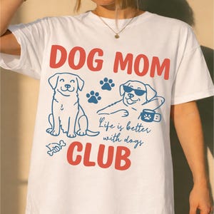 Model wearing a Dog Mom t-shirt with playful dog graphics and bold typography. Perfect for dog moms, pet owners, and animal lovers. Ideal for everyday outfits and custom apparel shops.