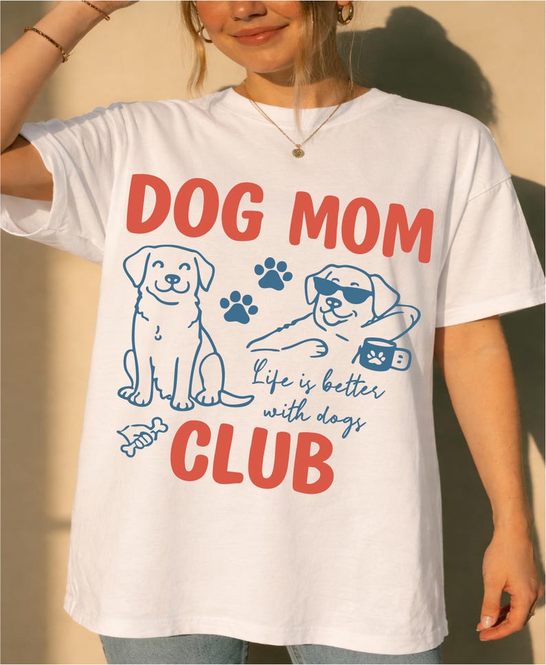 Model wearing a Dog Mom t-shirt with playful dog graphics and bold typography. Perfect for dog moms, pet owners, and animal lovers. Ideal for everyday outfits and custom apparel shops.