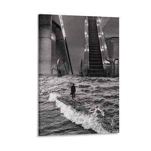 May include: Black and white art print depicting a person standing in turbulent water in front of an escalator. The image has a surreal quality, with the water level appearing to flood the building's interior. The print is mounted on a white background.