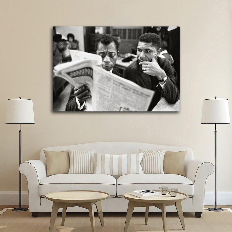 May include: Black and white photograph of two men reading a newspaper. One man is holding the newspaper, while the other is looking on with a thoughtful expression. The image is a portrait, likely of historical figures.