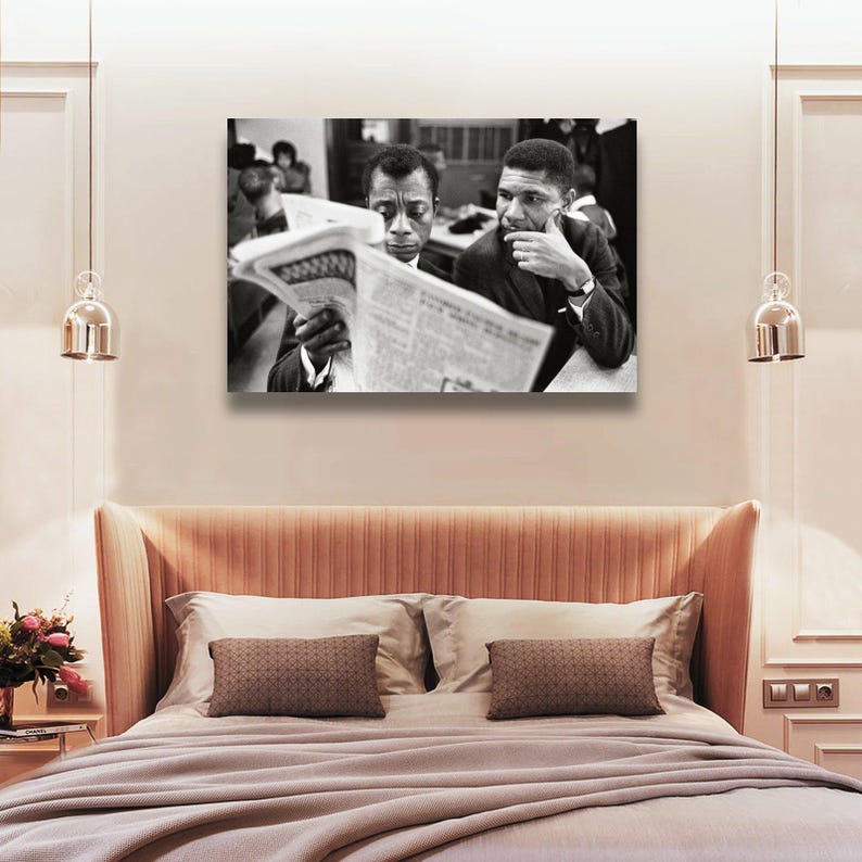May include: Black and white photograph of two men reading a newspaper. One man is holding the newspaper, while the other is looking on with a thoughtful expression. The image is a portrait, likely a historical or artistic print.