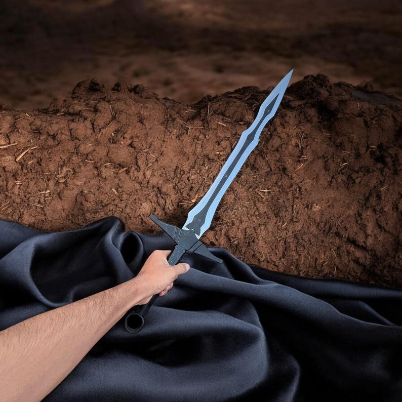 May include: A black and light blue sword with a crossguard and a long, pointed blade. The sword is held against a dark blue fabric and a brown, textured background.