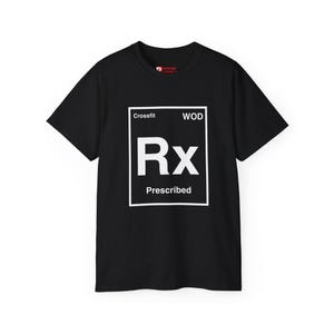 May include: Black t-shirt with a white graphic. The graphic includes the words "Crossfit" and "WOD" at the top, with "Rx" in a box, and "Prescribed" below. The shirt is a crew neck.