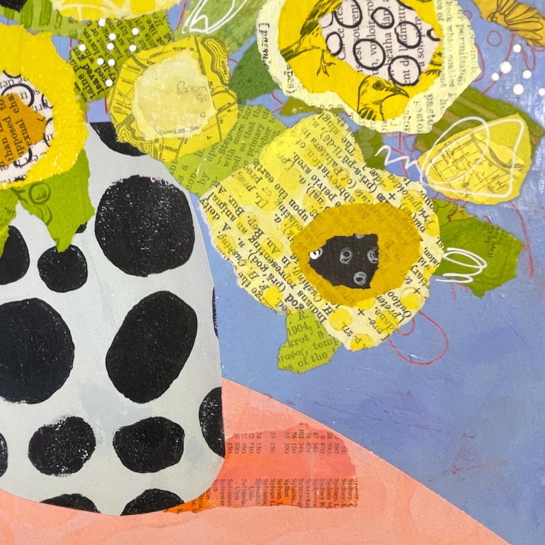 May include: A mixed media artwork featuring a vase with black polka dots holding yellow paper flowers. The flowers have a collage design with text and green leaves. The background is a mix of blue, pink, and white.
