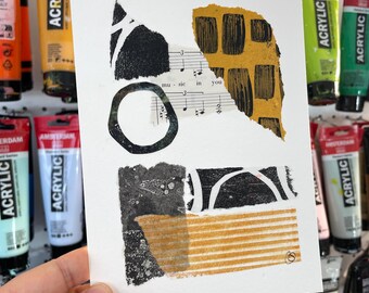 May include: A white card with black and yellow abstract shapes and a piece of sheet music with the words "music in you".