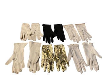 May include: A collection of ten pairs of gloves in various colors and materials, including black, white, and gold. The gloves are arranged in two rows, with five pairs in each row.