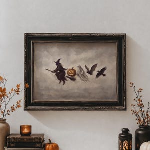 May include: A rectangular framed wall art piece featuring a painting of a witch on a broomstick, a glowing jack-o'-lantern, a white ghost, a bat, and a black crow flying against a cloudy gray sky, all enclosed in a dark, ornate wooden frame.
