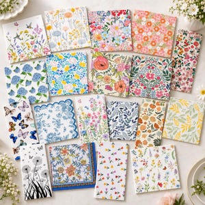 May include: A collection of square paper napkins featuring various floral, botanical, and butterfly patterns in diverse color palettes including blue, pink, yellow, and green. The designs include hydrangea clusters, wildflower meadows, and intricate foliage.