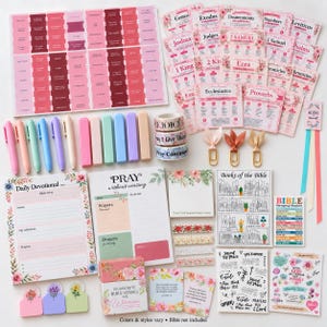 May include: A collection of Bible study supplies including pink and floral tab stickers, devotional notepads, colorful pens, washi tape rolls, paper clips, and decorative cards with floral motifs and religious text like Pray Without Ceasing.