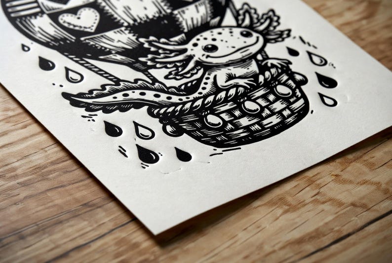 May include: Black and white illustration of an axolotl in a hot air balloon basket. The balloon has a heart design. Raindrops are falling around the basket. The art is on a white paper.