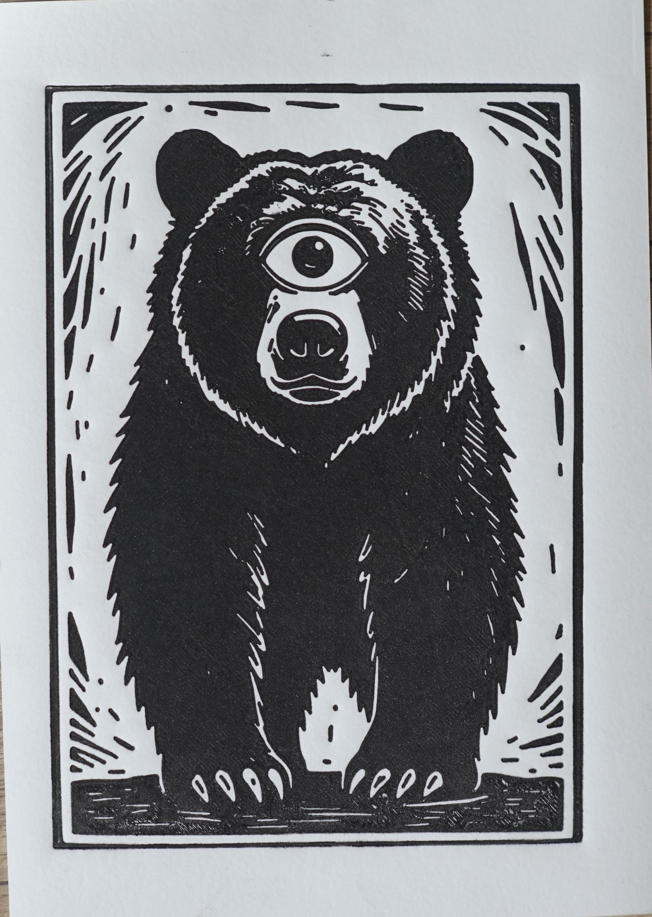 Hand-printed Surreal Cyclops Bear Linocut Print A5 art print — black ink on white cotton paper