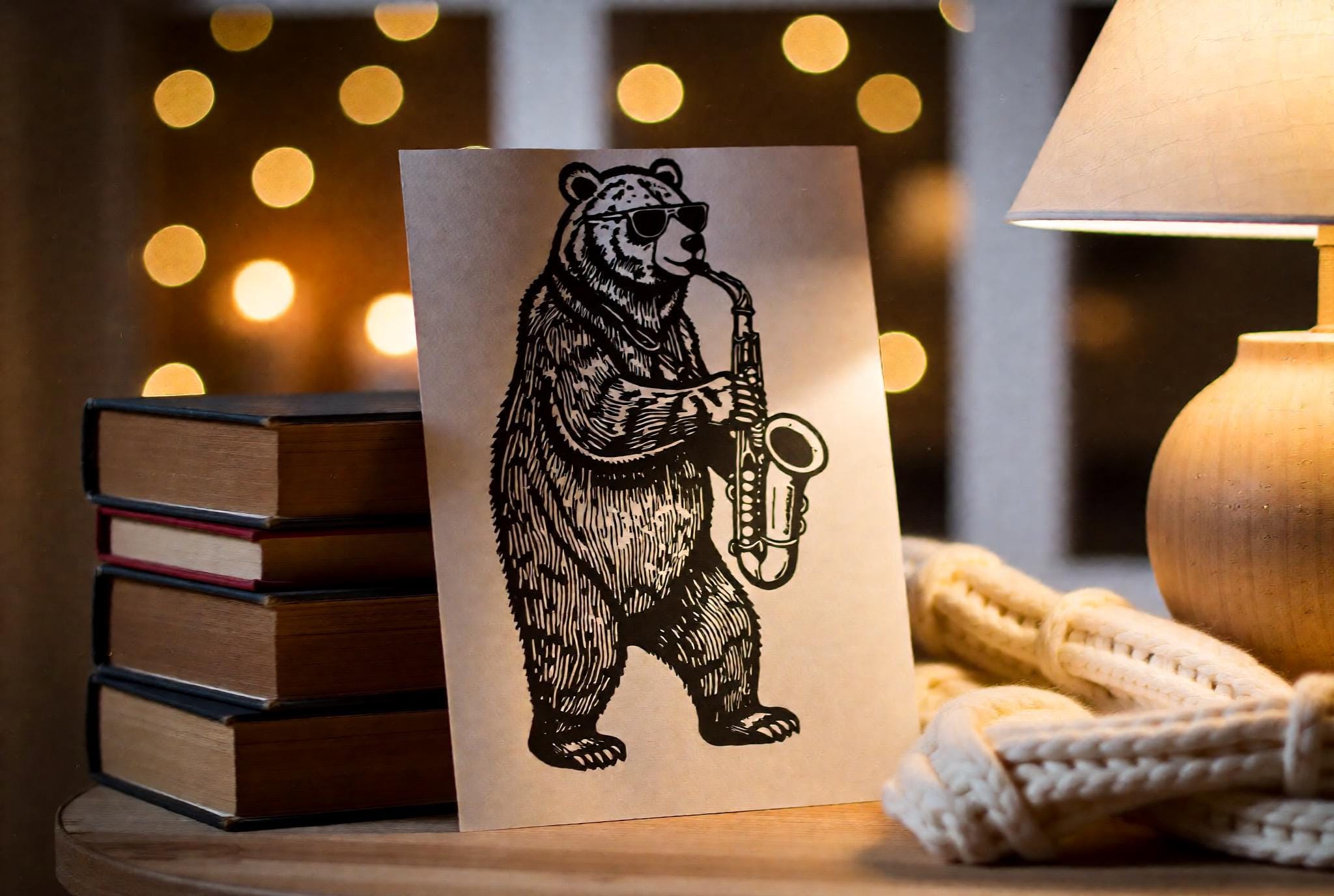 Handmade linocut print of a bear playing saxophone wearing sunglasses in a jazz club style