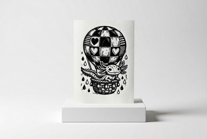 May include: Black and white illustration of an axolotl in a hot air balloon. The balloon has a patchwork design with heart shapes. The axolotl is in a woven basket, with rain drops falling around it.