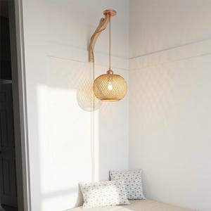 May include: A hanging pendant light with a woven, spherical shade. The light fixture is suspended from a wooden arm attached to the wall. The light has a warm, inviting glow, casting a circular shadow on the wall. The fixture is a decorative element.