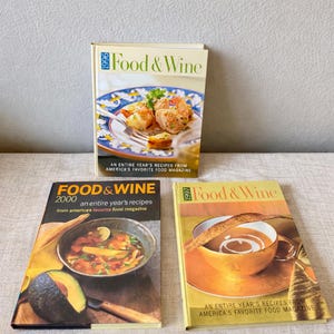 May include: Three vintage "Food & Wine" magazines from 1996, 1997, and 2000. The covers feature colorful food photography, including shrimp, soup, and a cup of coffee. Each magazine is labeled with the year and the magazine's title.