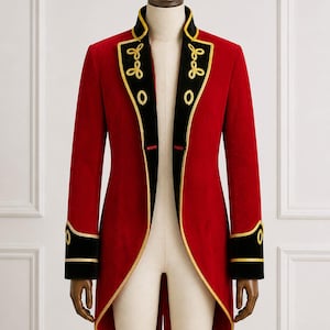 May include: A vibrant red tailcoat with black and gold trim, displayed on a mannequin. The coat features gold embroidered details on the collar and cuffs, and a tailored fit. The design is reminiscent of a military or theatrical style.