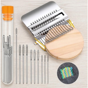May include: A collection of sewing tools, including a needle threader, a variety of needles in a clear tube, and a wooden weaving tool with metal hooks. A small swatch of fabric shows colorful thread embroidery.