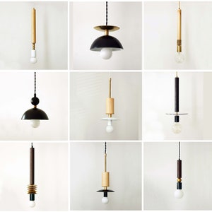 May include: Nine different pendant lights with black and wood accents. The lights have a variety of shapes and sizes, including round, square, and rectangular. Some of the lights have a single bulb, while others have multiple bulbs.