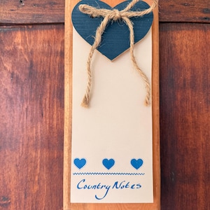 May include: A rustic wooden sign with the text "Welcome to our home" in white lettering. The sign features a distressed finish and a simple, inviting design, perfect for front door decor.