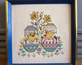 Pollitos de Pascua en una cesta, bordado vintage en punto de cruz - flores. Pollitos de colores brillantes, estilo kitsch, bordado en punto de cruz azul enmarcado E1.