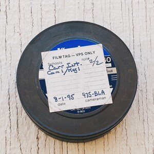 May include: A black film canister with a white label that says "FILM TAG - VPS ONLY" and has handwritten text that says "Carr Int. 2/20 Cam 1/Mag!" and "8-1-95 475-BLA date cameraman".