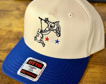 Gorra snapback Otto de Connor Hellebuyck Save, color natural/azul - NHL / Juegos Olímpicos 2026