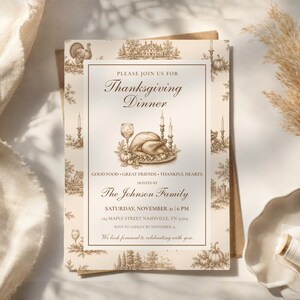 May include: A rectangular Thanksgiving dinner invitation card featuring a brown ink illustration of a roasted turkey, candles, and a wine glass. The text reads: Please join us for Thanksgiving Dinner, Good Food, Great Friends, Thankful Hearts, hosted by The Johnson Family, Saturday, November 21 at 6 PM, 123 Maple Street Nashville, TN 37203, RSVP to Ashley by November 14, We look forward to celebrating with you.
