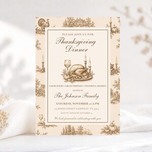 May include: A rectangular Thanksgiving dinner invitation card with a cream background and brown ink illustrations. The border features a toile pattern of turkeys, pumpkins, and houses. The centre displays a roasted turkey, wine glass, and candles.