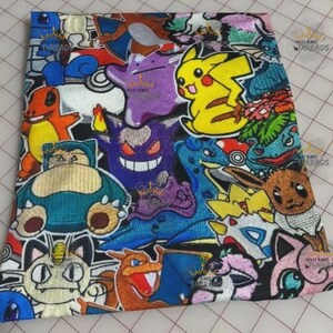 May include: Embroidered fabric featuring a collage of colorful cartoon characters, including Pikachu, Charmander, and Snorlax, on a black background. The design includes the text "These Kings Threads" in a repeating pattern.