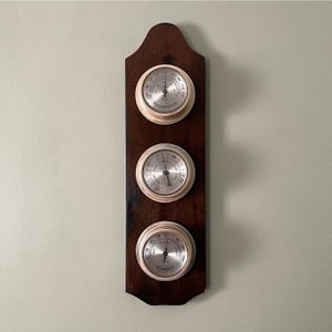 May include: A set of three ceramic nesting bowls in graduating sizes. The bowls are white with a speckled, textured finish. The largest bowl is approximately 7 inches in diameter, the medium bowl is 6 inches, and the smallest is 5 inches.