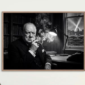 Peut inclure: Tirage encadré en noir et blanc d'un homme en costume fumant un cigare. L'homme est assis à un bureau avec une lampe, une machine à écrire et des livres. L'arrière-plan montre une fenêtre avec une vue sur une ville la nuit.