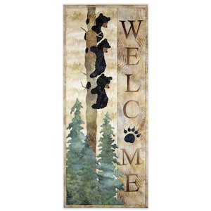 May include: A rectangular vertical sign featuring a forest scene with three black bears climbing a tree trunk. The word WELCOME is printed in large brown letters on the right side, with a black bear paw print replacing the letter O.