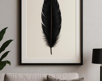 May include: A framed art print featuring a detailed black feather with a gold-colored central vein. The feather is set against a cream-colored background within a black frame. The artwork is displayed above a light-colored sofa with a dark gray pillow.
